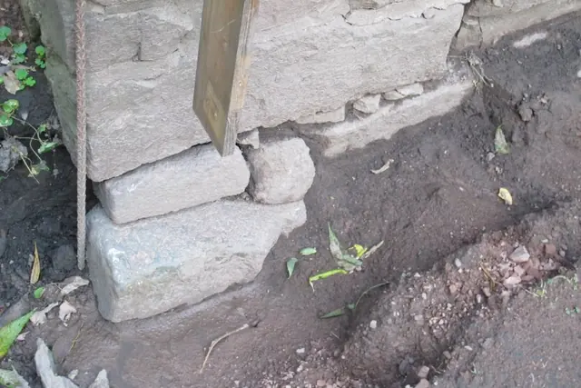 Image #1: failed foundation plinth at NW corner, below grade