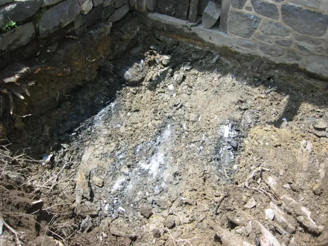 2634--Brittle top layer of lmestone bedrock found 18" below top of door sil