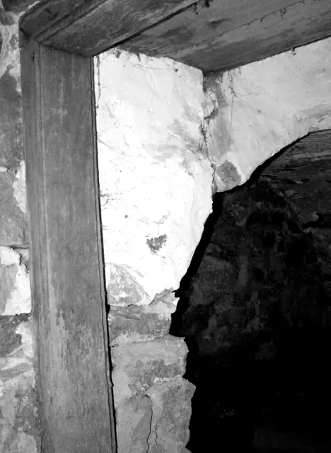 Cellar door jamb & arched opening into root cellar